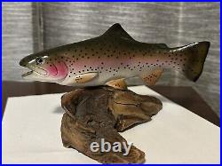 B. Reel signed Trout (possibly a Big Sky Carvers piece)