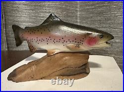 B. Reel signed Trout (possibly a Big Sky Carvers piece)
